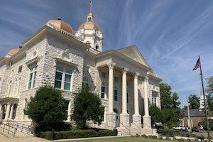 Shelby County District Court building with white stone columns and dome.